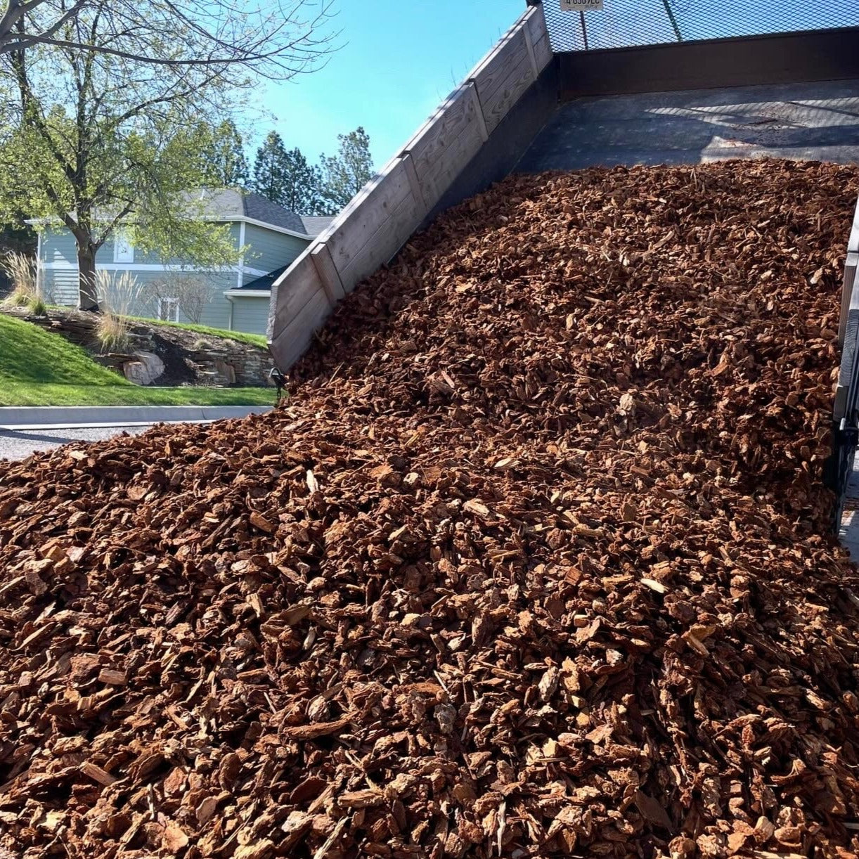 Nugget bark being dumped out of small dump truck