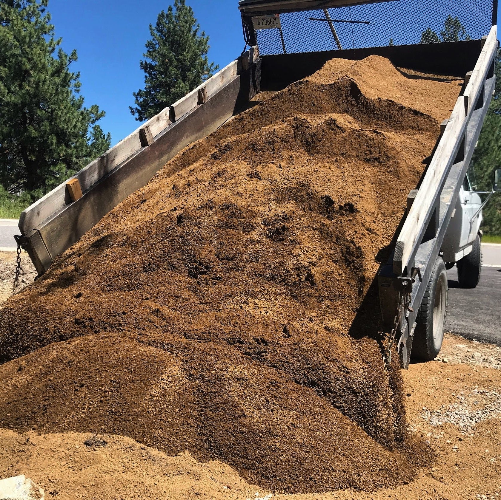 Big dump of decomposed granite from dump truck in Lolo Montana.