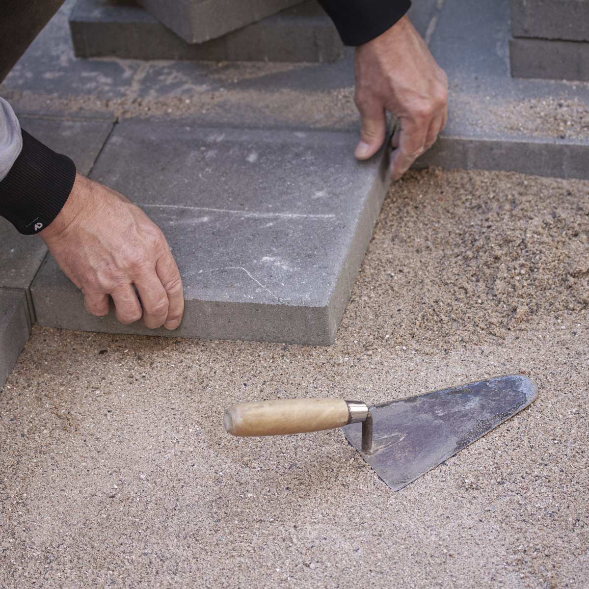 Washed sand being used in a paver patio project.