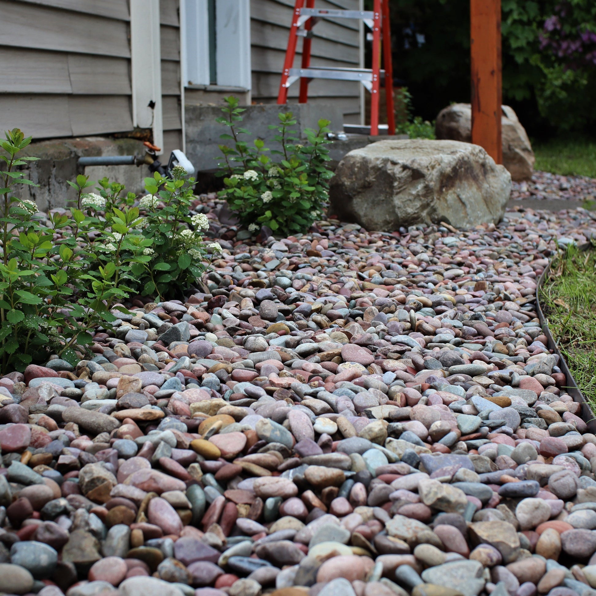 1.5 inch round river rock landscape material used in a landscape on the north side of Missoula.